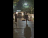 Three girls roll down slope pavement night