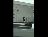 Red shirt girl sits shopping cart dumpster 