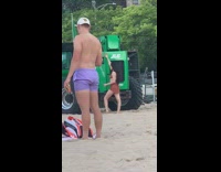Woman brown bikini twerks in front of green tractor