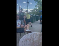 Two men and a woman tiktok dance near the garbage bins