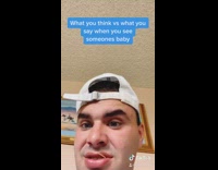 Guy holds baby boy ugly no eyebrows 