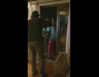 Two guys carry large pan through door