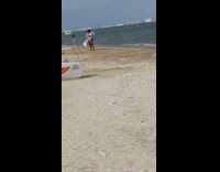 Woman white bikini long cardigan windy beach