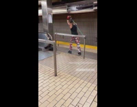 Guy does arm workout in subway station