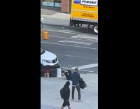 Guy lays on back plays trumpet sidewalk