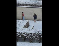 Woman brown coat red top snowy park 