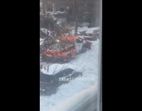 Orange white snowplow gets stuck in snow 