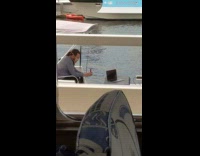 Guy face mask takes photo laptop port