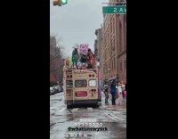 People dressed in animal costumes dancing on bus and sidewalk