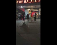 Girls take photos outside restaurant 