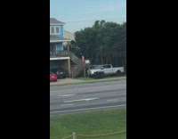Woman pink bikini poses on stairs front yard