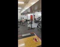 Guy in gym needs help while couple squats each other