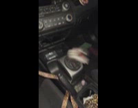 Womans gear shift on car flailing uncontrollably