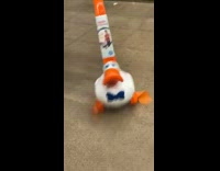 White duck on stick toy moving on floor turns and runs