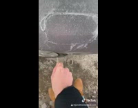 Girl cries and carves out ice on fuel tank cap with keys