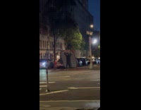 Man carry air bed cross the street