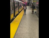 Female dancer in black bikini does splits against train 