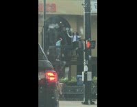 Man in blue stole poses at the stairway