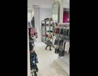 Boy dances in clothing store mirror
