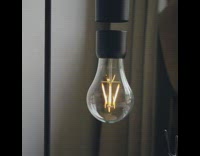 Black lightbulb light rotates magnet design table