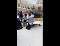 Man purple hat play piano Oculus mall