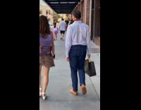 Couple walks with guy attached to leash and collar 