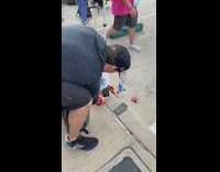 two runners pose no sidewalk with medals