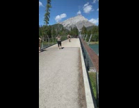 Girl black dress kick up bridge mountain