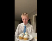 Boy in formal attire eats and dances