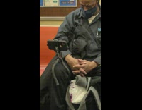 Guy watches phone with tripod around knee 