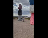 Tourists take pictures stack giant colorful rocks