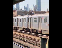Guy climbs on top of departing train to subway surf