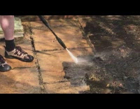 Guy power wash ground remove old dirt