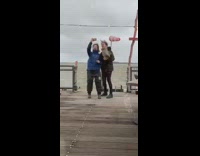 Two ladies take selfie in rain storm 