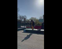 Man in yellow track suit and batman face mask