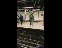 Man wearing christmas tree waiting for his subway to come