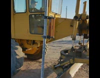 guy inside brown tractor music playing