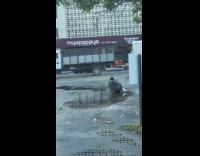 Person sits water puddle white cast leg 