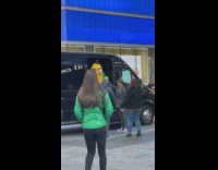 Man Assists Elderly in Costume Unload Van 