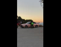 Two girls twerk pink chrome car sunset 