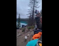 Woman white dress poses by the lake