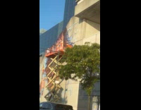 Collab WINY - Woman paints large artwork on building wall