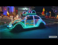 Parked car covered in colorful christmas lights 