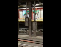 Guys stands in overalls and green wigs 