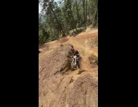 Boy rides dirt bike up steep wall lands on top