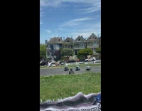 Guy three robot delivery vehicles orange flags