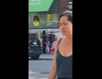 Guy with skis walks down sidewalk 