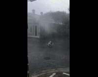 Man raincoat wet middle street film hurricane