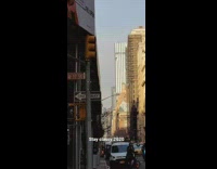 Small fire burns on sidewalk by street 