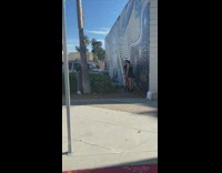 Two girls hug black mural parking lot
